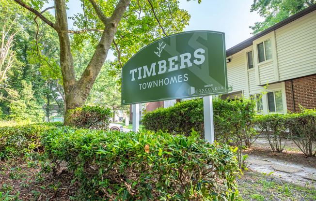 a sign that says timbers townhomes in front of a building