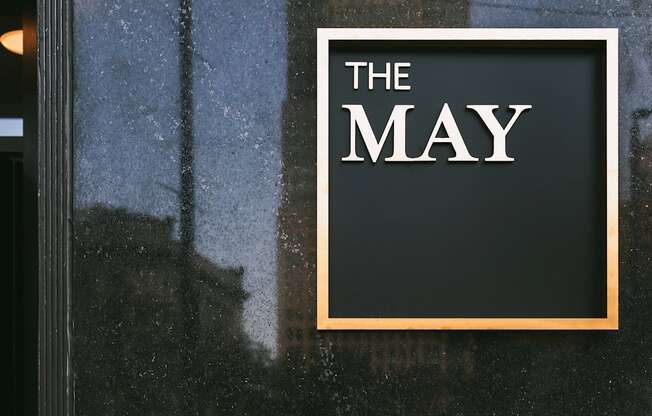 The May, exterior signage in gold.