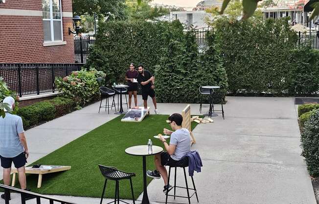 Residents enjoying games in the Courtyard at West 130 , West Hemopstead, NY