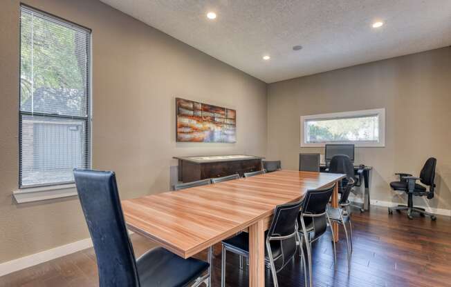 a meeting room with a large wooden table and chairs