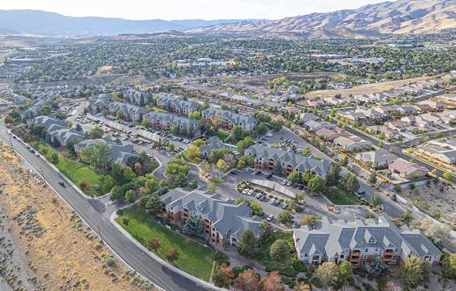 an aerial view of a neighborhood with houses and a highway