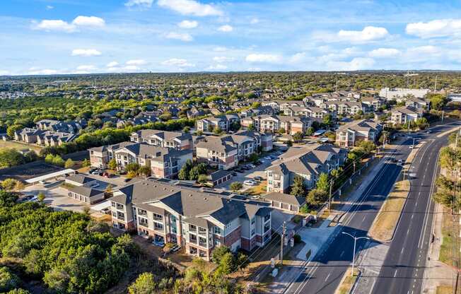 A bird's eye view of a residential area with houses and roads. at Bridge at Southpark Meadows, Austin, Texas
