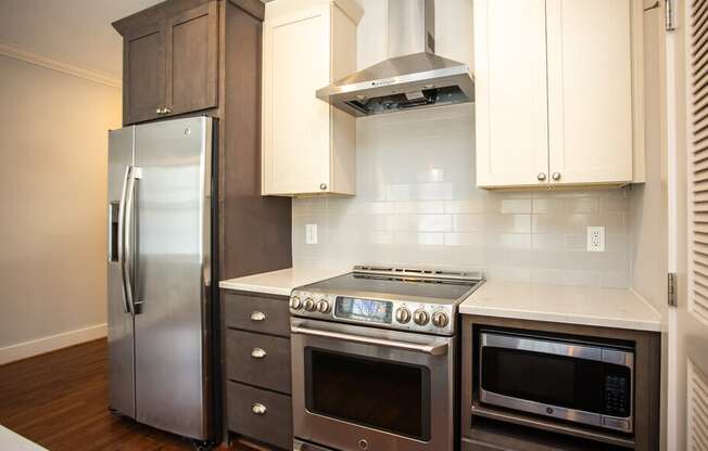 A modern kitchen with stainless steel appliances and wooden cabinets.