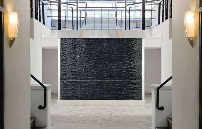 a large black water fountain in the middle of a building at Tindeco Wharf, Baltimore, MD