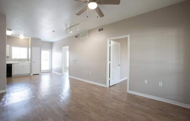 A room with a ceiling fan and light fixture.