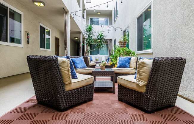 a patio with wicker furniture and a coffee table