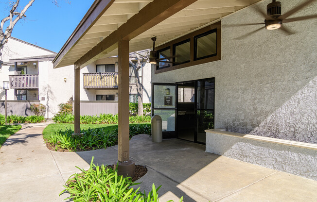 A building with a concrete wall and a black door.