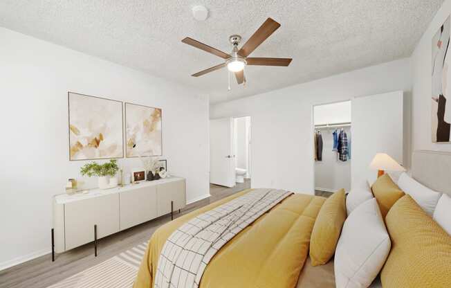 a bedroom with a large bed and a ceiling fan