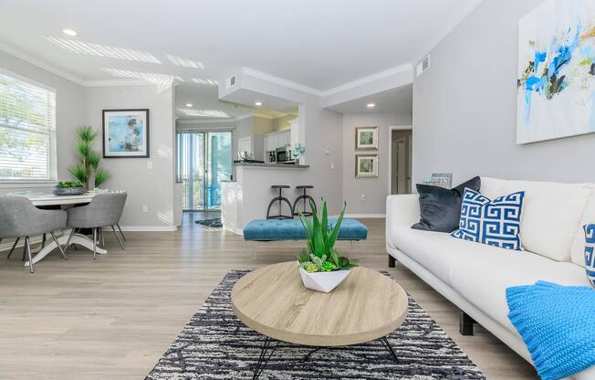 a living room filled with furniture and a large window