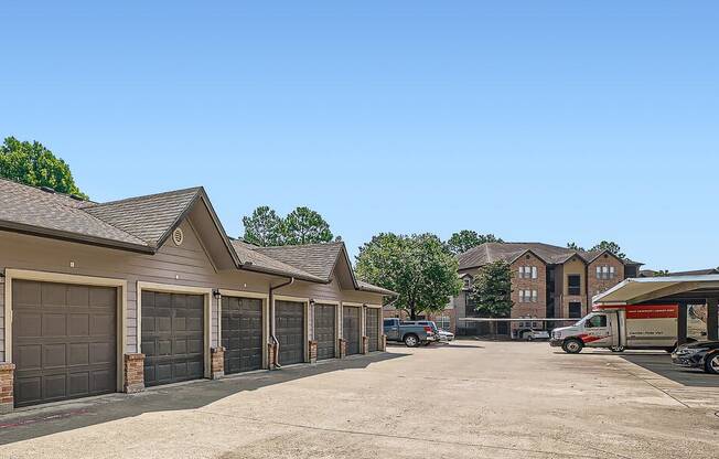 a parking lot with a row of garage doors at River Pointe, Conroe, TX