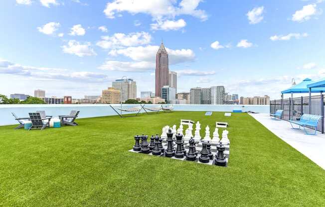 A giant chess set is set up on a lawn.