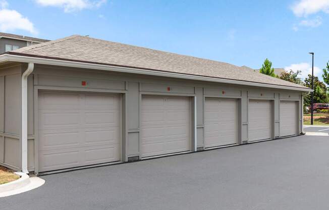 A building with grey garage doors and a brown roof.