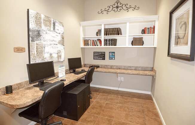 a home office with two computer desks and two chairs