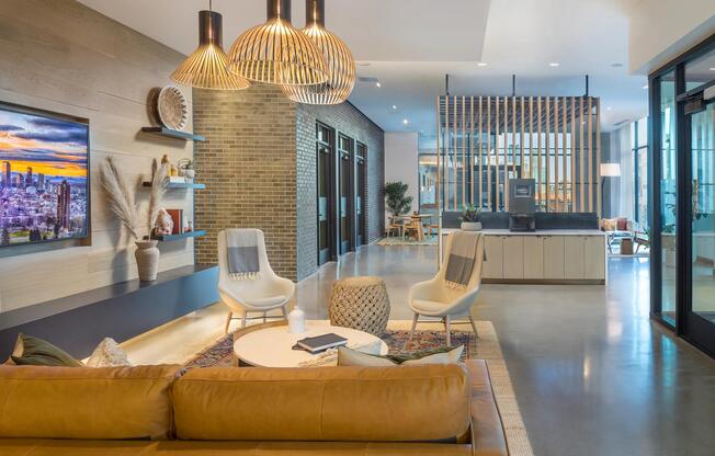 Indoor-outdoor bar and lounge area with kitchen and flat screen TVs.