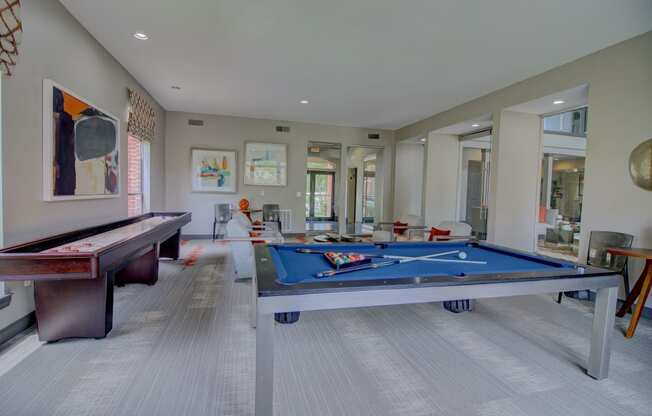 a games room with a pool table and ping pong table