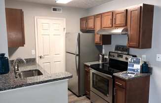 a kitchen with granite counter tops and stainless steel appliances
