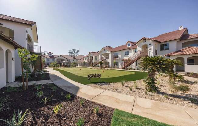 A sunny day in a residential neighborhood with houses and a park.