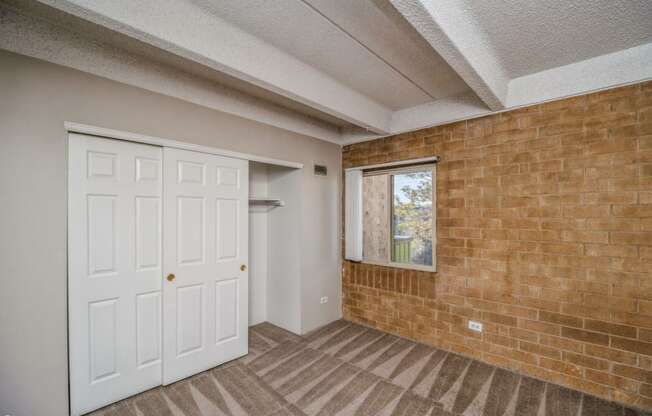 Bedroom with a large closet and plush carpeting