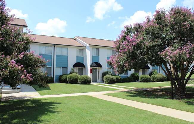 lush courtyard with sidewalk, fenced dog park, and lush landscaping  at Huntsville Landing Apartments, Huntsville