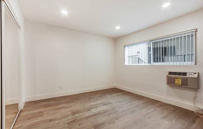 a living room with white walls and a window