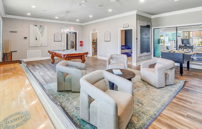 a living room with a pool table and couches at The Vineyard of Olive Branch Apartment Homes in Olive Branch, 38654