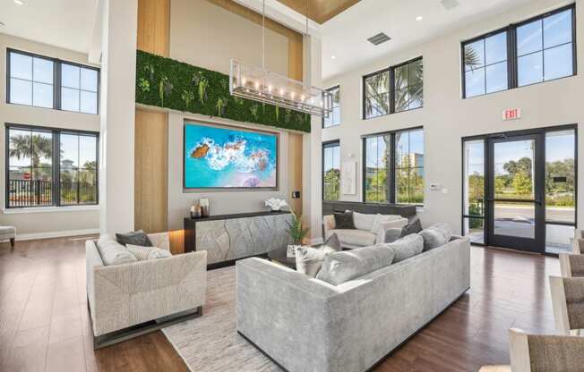 a living room with couches and a tv on the wall at Drift, Daytona Beach, FL, 32117