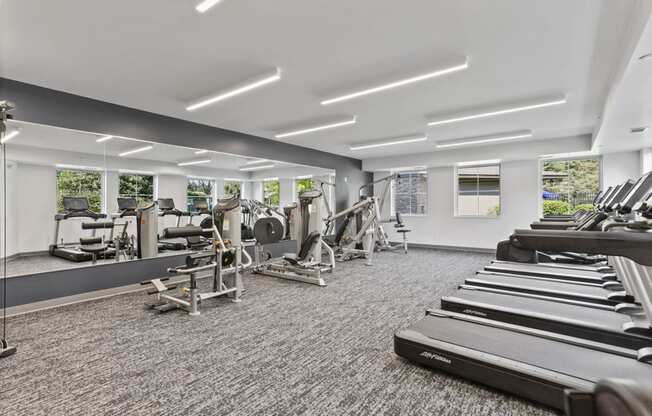 a gym with treadmills and other exercise equipment