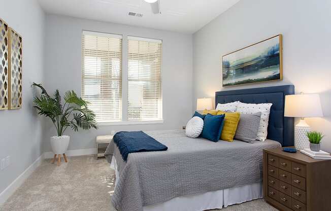 Primary bedroom with bed and side tables at St Mary's Square North Apartments, Raleigh, North Carolina