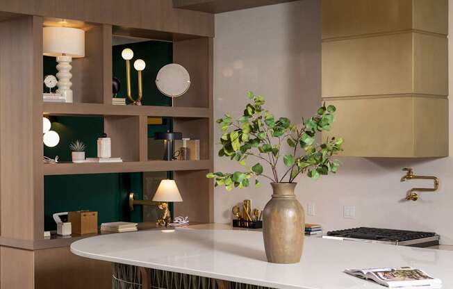 A kitchen with a white counter and brown stools.