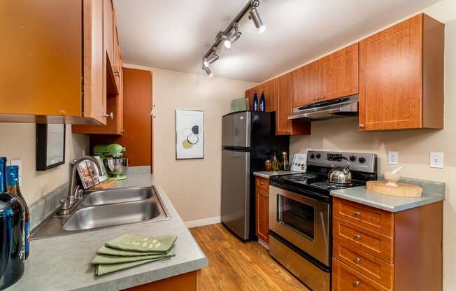 a kitchen with wooden cabinets and stainless steel appliances