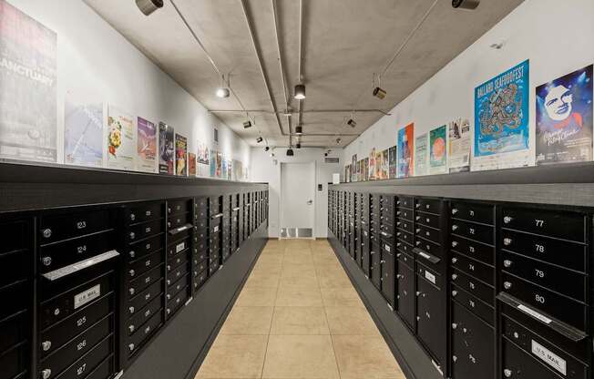 A long hallway with black drawers on both sides and posters on the wall.
