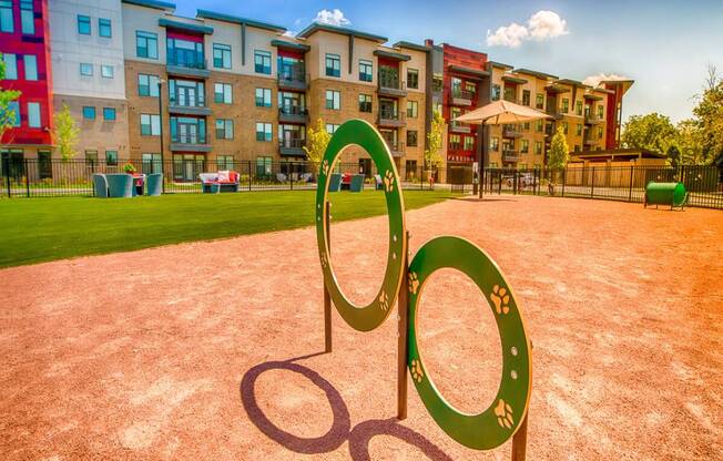 a sculpture in the shape of a peace sign in front of an apartment complex