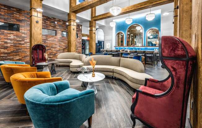 a lobby with couches and chairs and a bar at The Alibi at Lake Lilly, Ocoee, 34761