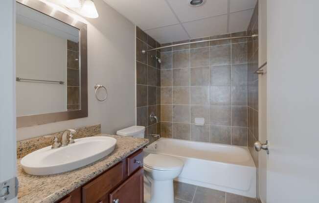 a bathroom with a sink and a toilet and a shower