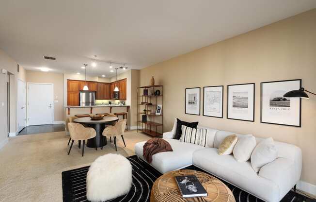 a living room with a white couch and a table and chairs