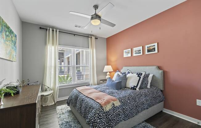 a bedroom with a bed and a ceiling fan