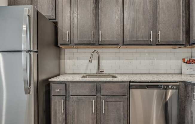 Kitchen with Dark Brown Cabinetry and Stainless Steel Appliances