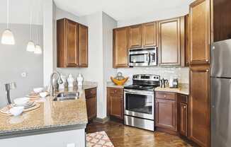 a kitchen with stainless steel appliances and granite counter tops