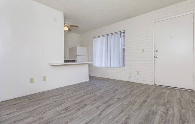 A room with a white ceiling, a white door, and a white cabinet.