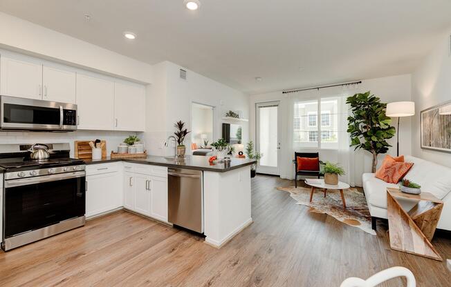 a living room filled with furniture and a counter in a kitchen