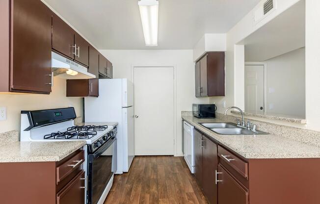 a kitchen with a stove sink and refrigerator