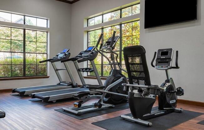 treadmill, elliptical, bicycle and other equipment in fitness room