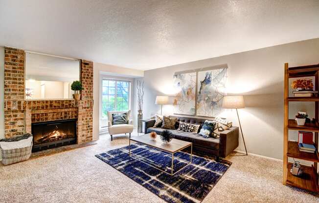 Apartments for Rent in Silverdale WA - Spacious Ridgetop Living Room with Carpeted Floors, Fireplace, and Stylish Interior