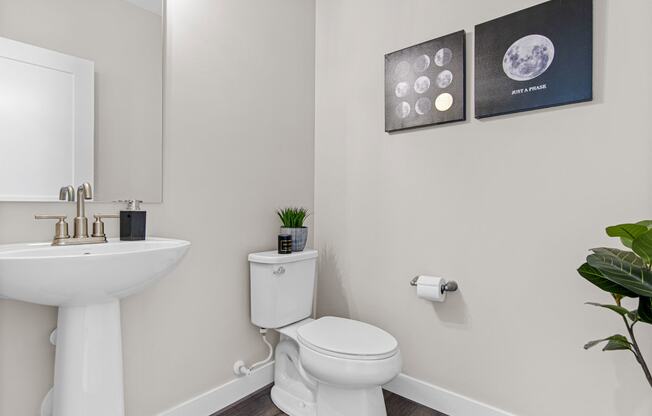 a bathroom with a toilet sink and mirror