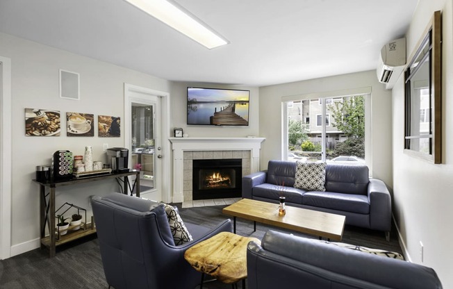 a living room with couches, wooden coffee table, and a fireplace at Willows Court Apartment Homes, Washington, 98125