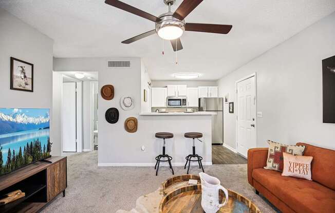 A living room with a brown couch and a wooden coffee table.