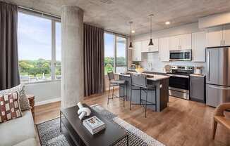 a living room with a kitchen and a dining room