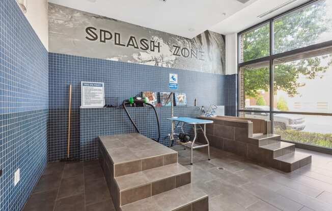 the entrance to thesplash zone with a bench and a table with a water hose