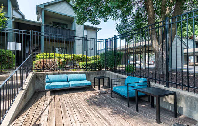 Wooden Deck with blue couch at Springhill Apartments, Overland Park