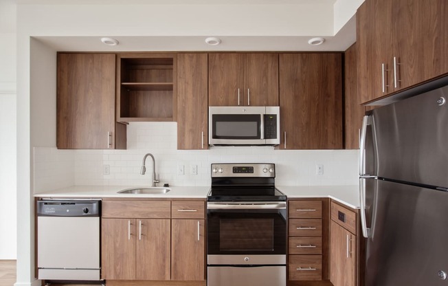 a kitchen with stainless steel appliances and wooden cabinets